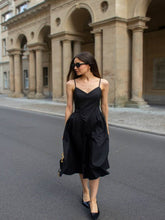 You can wear a linen blazer and a black midi dress.